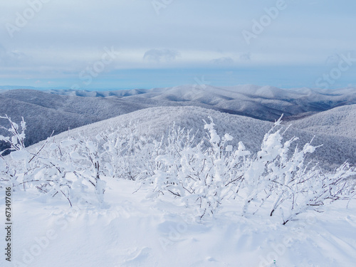 Fototapeta Naklejka Na Ścianę i Meble -  Winter mountain landscape. Mountain peaks covered with snow. View from Mala Rawka to Beskid Mounatin Range . Bieszczady Mountains. Poland