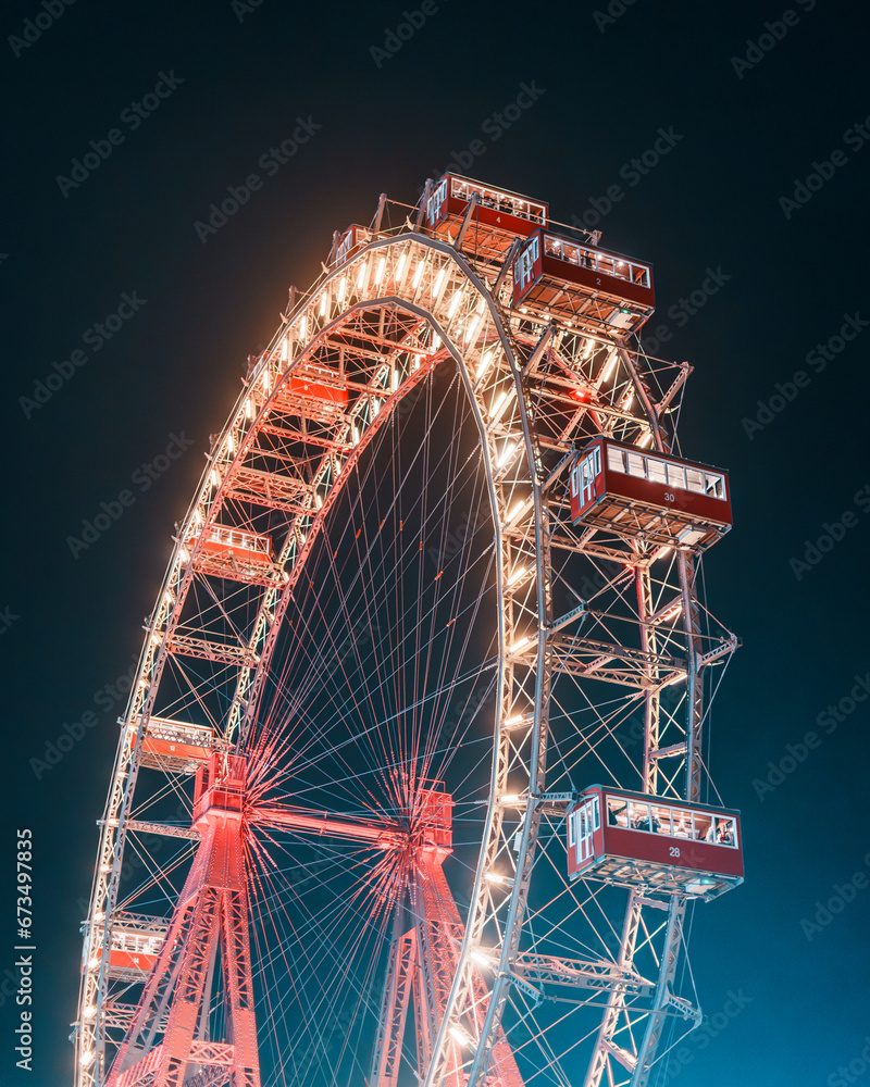 Fototapeta premium Wiener Riesenrad (Viennese Giant Ferris Wheel) at night at the Prater amusement park in Vienna, Austria