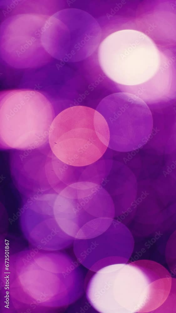 Beautiful defocused purple bokeh background. Christmas purple bokeh background lights sparkle Christmas background with abstract purple green light. vertical, vertical video background. Beautiful defocused purple bokeh background. Christmas purple bokeh background lights sparkle Christmas background with abstract purple green light. vertical, vertical video background.