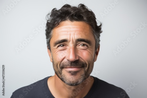 Handsome man with beard and mustache making funny face on grey background