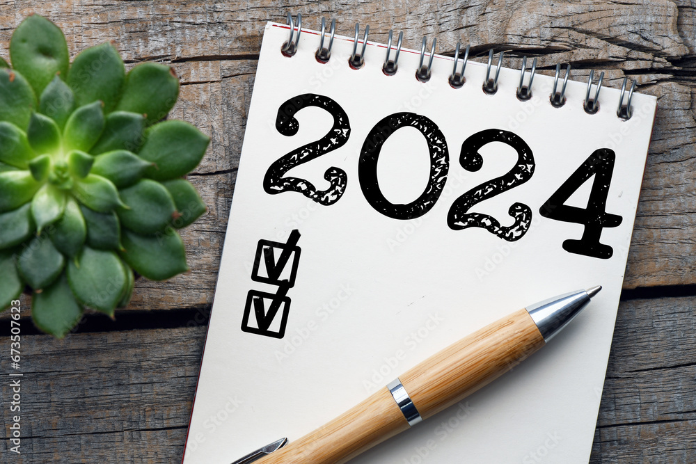 New year resolutions 2024 on desk. 2024 goals list with notebook