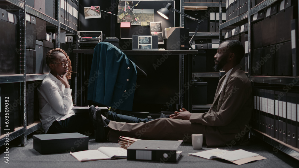 Team of detectives conducting criminal investigation in evidence room(01)