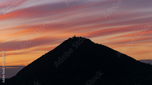 silhouette of the highest mountain in the Czech Central Mountains Milešovka at sunset photo