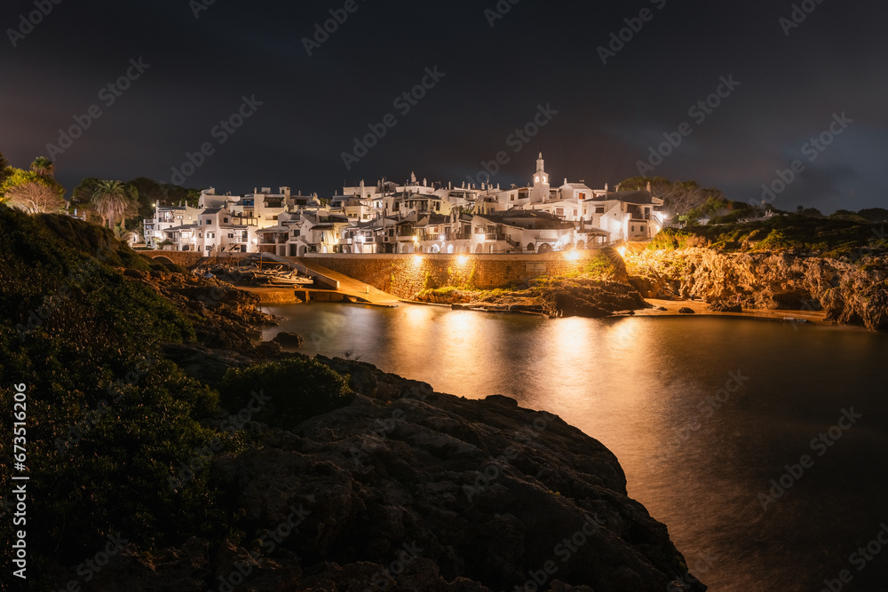 Panoramic view, at night, of Binibeca, a typical white mediterranean village, located on the southern coast of Menorca/Minorca island, in the Balearic Islands, Spain.