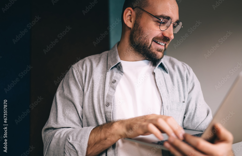 Focused male entrepreneur typing on computer during workday Focused male entrepreneur typing on computer during workday
