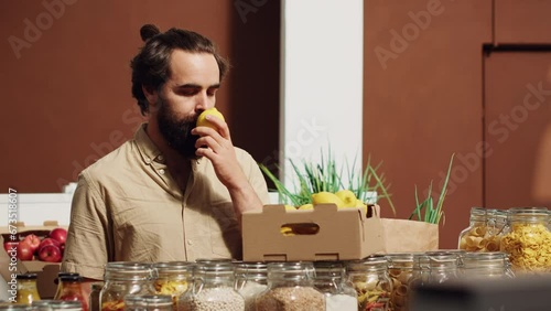 Man in low carbon footprint store feels dopamine rush while smelling lemons. Customer in local neighborhood grocery shop has nostalgic bliss moment seeing farm grown fruits, remembering childhood