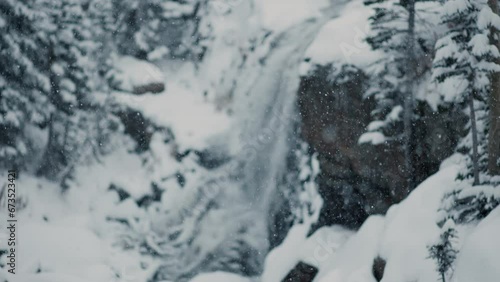 Wallpaper Mural Beautiful, scenic waterfall nestled in the mountains with snow falling down Torontodigital.ca