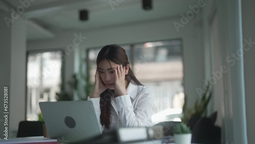 Asian woman bored with office routine