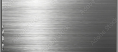 A brushed steel plate with reflections creates a metallic background or textured surface