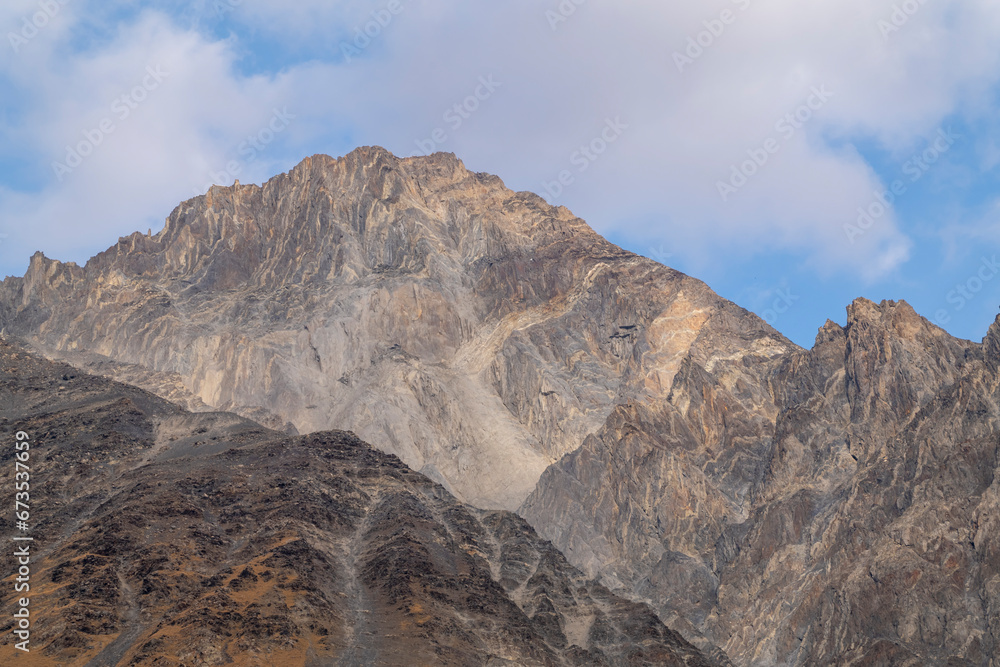 Kazbegi mountains view with blue sky and white clouds