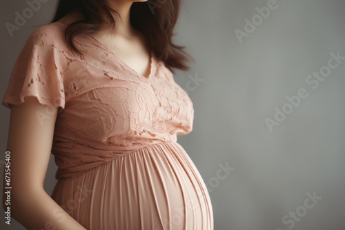 Image of pregnant woman touching her belly with hands