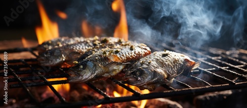Grilled Tilapia fish with a smoky flavor coated in salt and cooked on a charcoal grill A popular type of street food found in Thailand