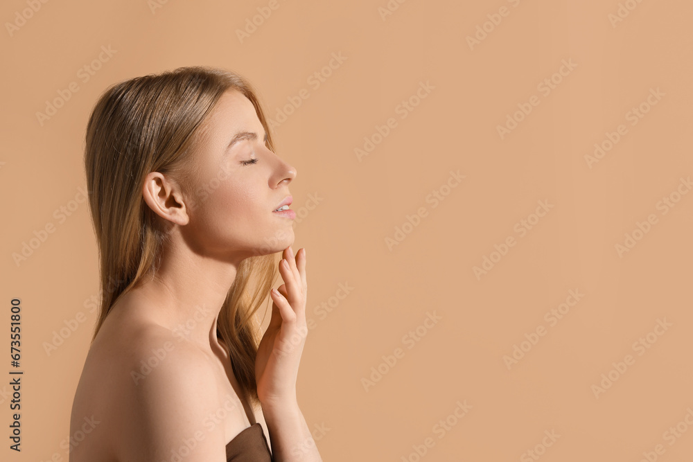 Fototapeta premium Beautiful young woman posing on beige background, space for text