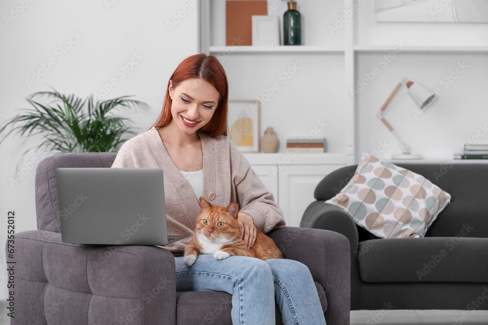 Happy woman with cat working in armchair at home, space for text Happy woman with cat working in armchair at home, space for text