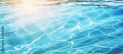 Sunlight reflects off the surface of the swimming pool creating rippling patterns in the water