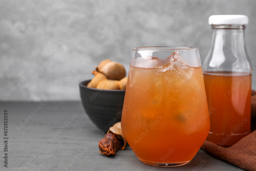 Freshly made tamarind juice on grey wooden table, closeup. Space for text Freshly made tamarind juice on grey wooden table, closeup. Space for text