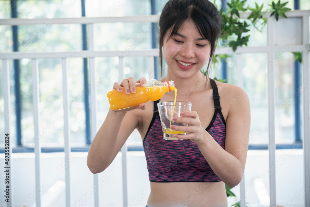 Women hands holding cold orange juice fresh fruit cool drinking. Asian women smile laugh look at camera health care home fitness lifestyle. Beautiful female pouring orange juice from cocktail bottle Women hands holding cold orange juice fresh fruit cool drinking. Asian women smile laugh look at camera health care home fitness lifestyle. Beautiful female pouring orange juice from cocktail bottle