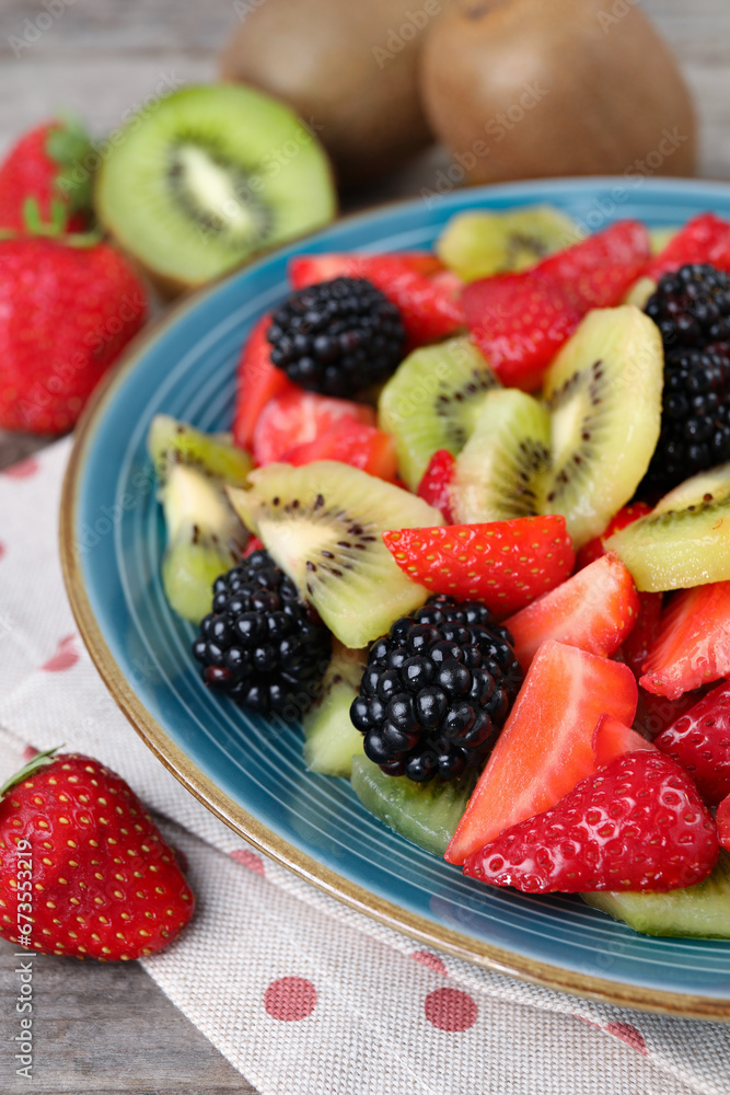 Plate of delicious fresh fruit salad on table, closeup Plate of delicious fresh fruit salad on table, closeup