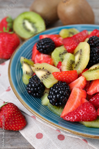 Plate of delicious fresh fruit salad on table  closeup