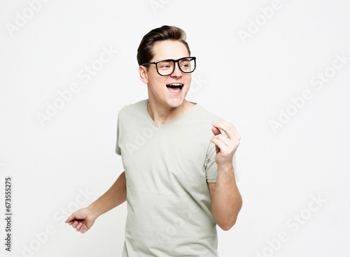 young man celebrating victory over white background