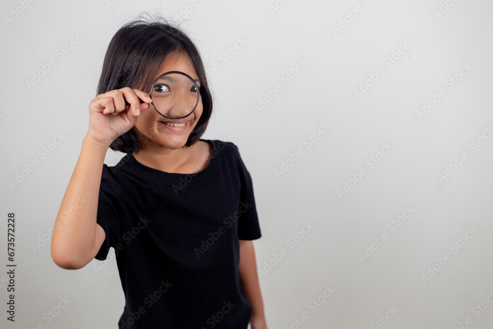 little girl looking through a magnifying glass little girl looking through a magnifying glass