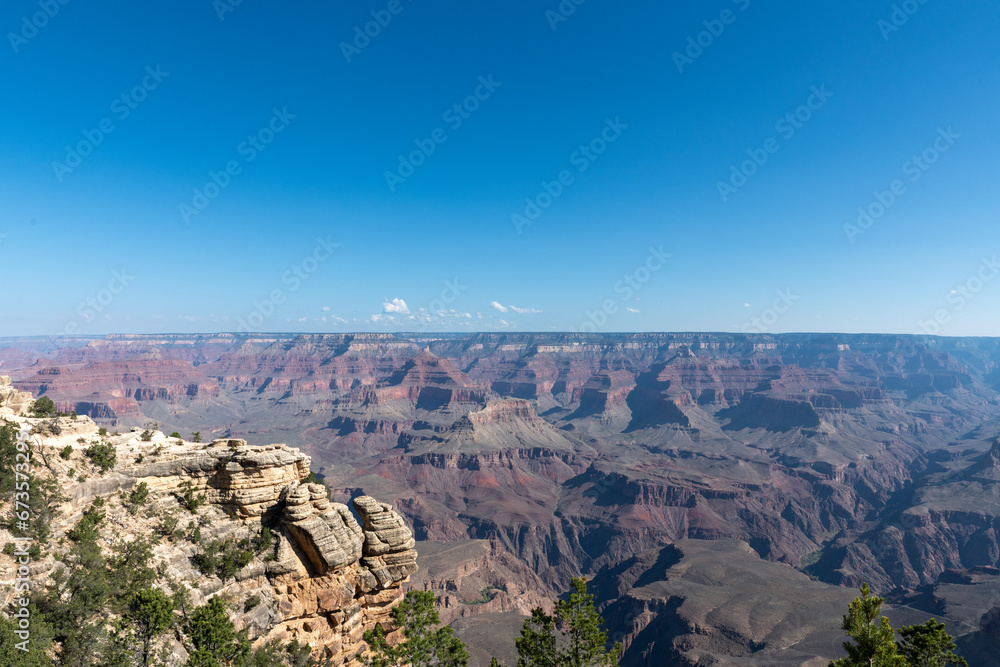 Wide angle image of the Grand Canyon on a clear day with bright blue sky. Taken from Mather Point along the south rim of the canyon.