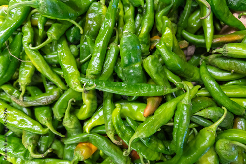 Close-up of a bushel of fresh green chile peppers, spicy food, southwest, autumn, winter, organic produce, green and red