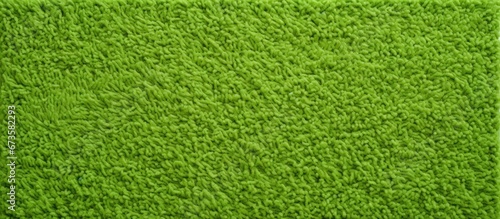 A warm greeting from a green foot scraper with a textured microfiber fabric background Up close you can see the pattern of a green fabric towel texture on the surface