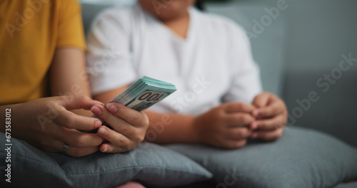 Portrait close up of young women and teen girl counting cash money on sofa in the living room at home,Happy counting dollars banknote.