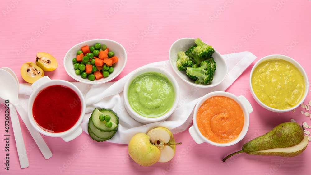 Bowls with baby food on pink background. Healthy eating concept. Bowls with baby food on pink background. Healthy eating concept.