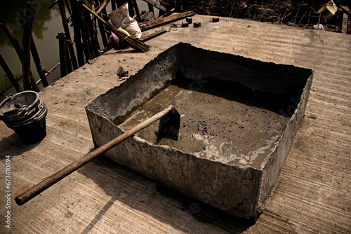 basin, hoe, concrete, worker, employee, cement in a large basin. Jungle, Asia, broom