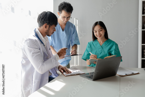 A group of male and female doctors sat and talked about the patient's history, There was a meeting about major surgery, The doctor takes the patient's documents and discusses them with team.