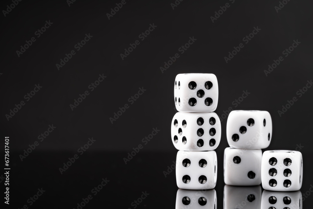 White dice on black background studio shot White dice on black background studio shot