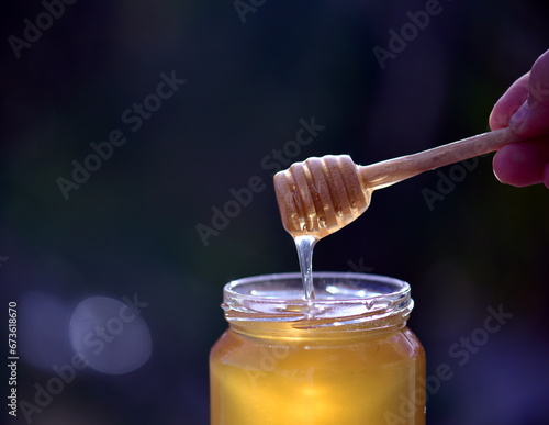 honey dripping from a jar