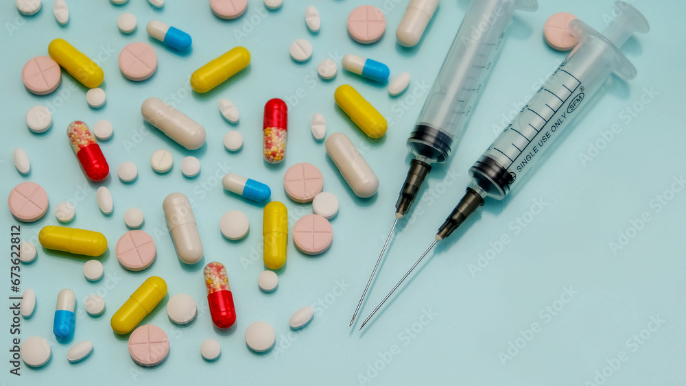 Pills and capsules with medicines on a blue background, there is space for copy. Pills and capsules with medicines on a blue background, there is space for copy.