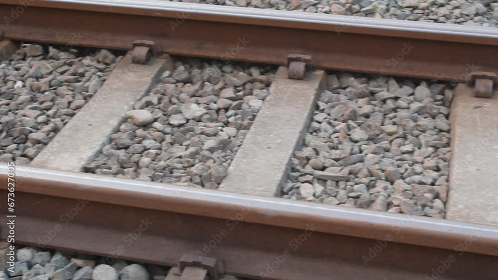 A closeup of the railroad tracks stretching into the distance with the city in the background on a summer morning on the horizon. A closeup of the railroad tracks stretching into the distance with the city in the background on a summer morning on the horizon.