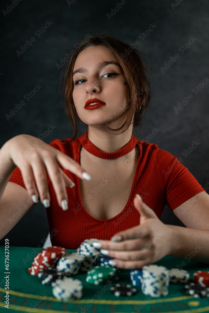 woman's hand takes poker cards at a round green poker table. risky bets in poker woman's hand takes poker cards at a round green poker table. risky bets in poker