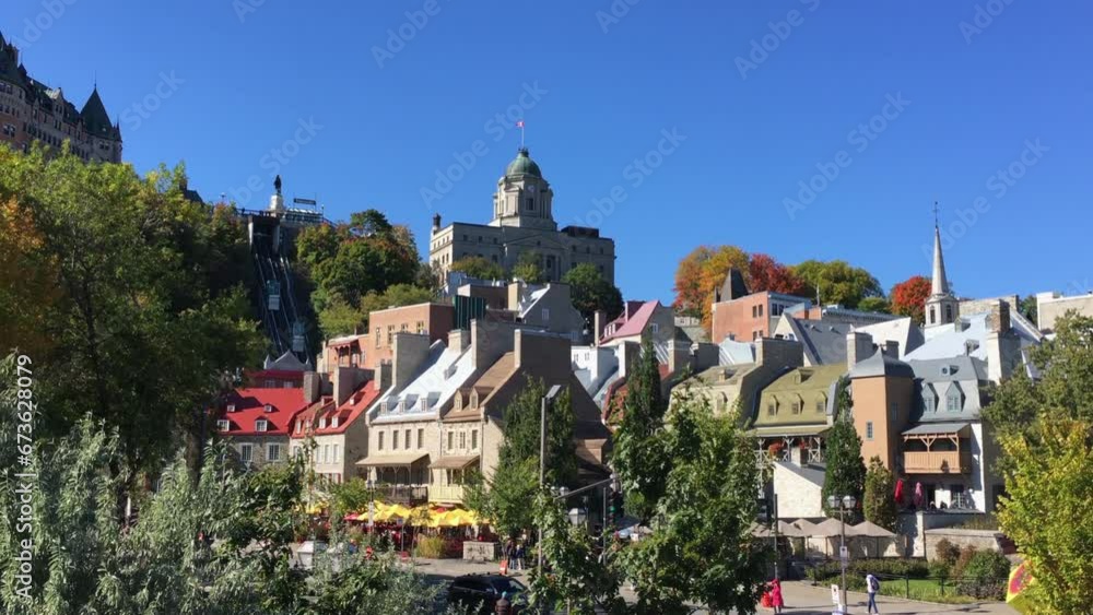 The funicular cars pass near the Frontenac Chateau in Quebec City, Canada. The Louis St. Laurent building crowns the hill while the quaint and colorful Lower Petit Champlain area is below. The funicular cars pass near the Frontenac Chateau in Quebec City, Canada. The Louis St. Laurent building crowns the hill while the quaint and colorful Lower Petit Champlain area is below.