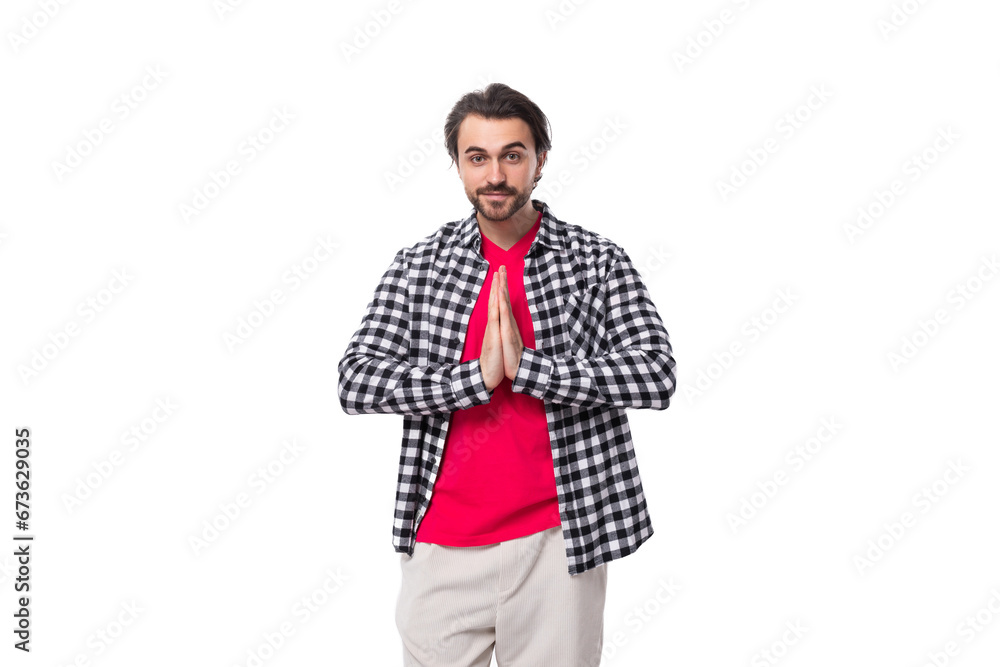 young handsome European brutal guy with gorgeous hair and beard folded his hands together young handsome European brutal guy with gorgeous hair and beard folded his hands together
