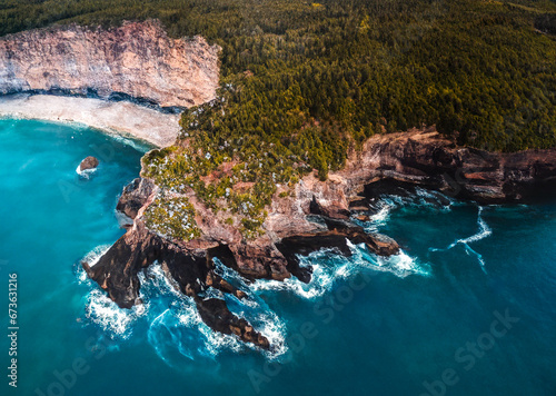Flatrock, NL, Canada Turquoise sea coast surrounded by rocky cliff covered with lush trees 