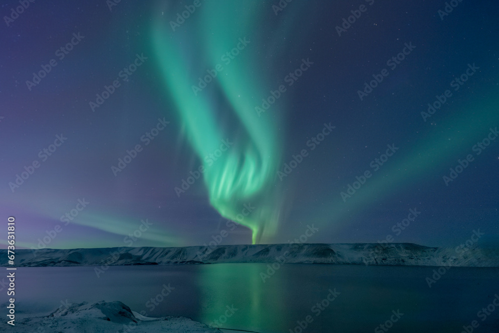 Iceland Northern Lights Above Lake and Snowy Landscape