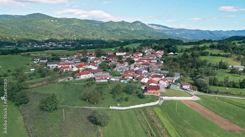 A small old village in the middle of a hill with high hills in the background. Drone footage, Slovenia A small old village in the middle of a hill with high hills in the background. Drone footage, Slovenia