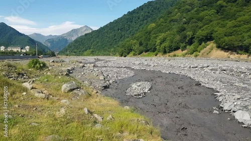 Muddy River Water Flowing in Landscape of Azerbaijan on Sunny Summer Day photo