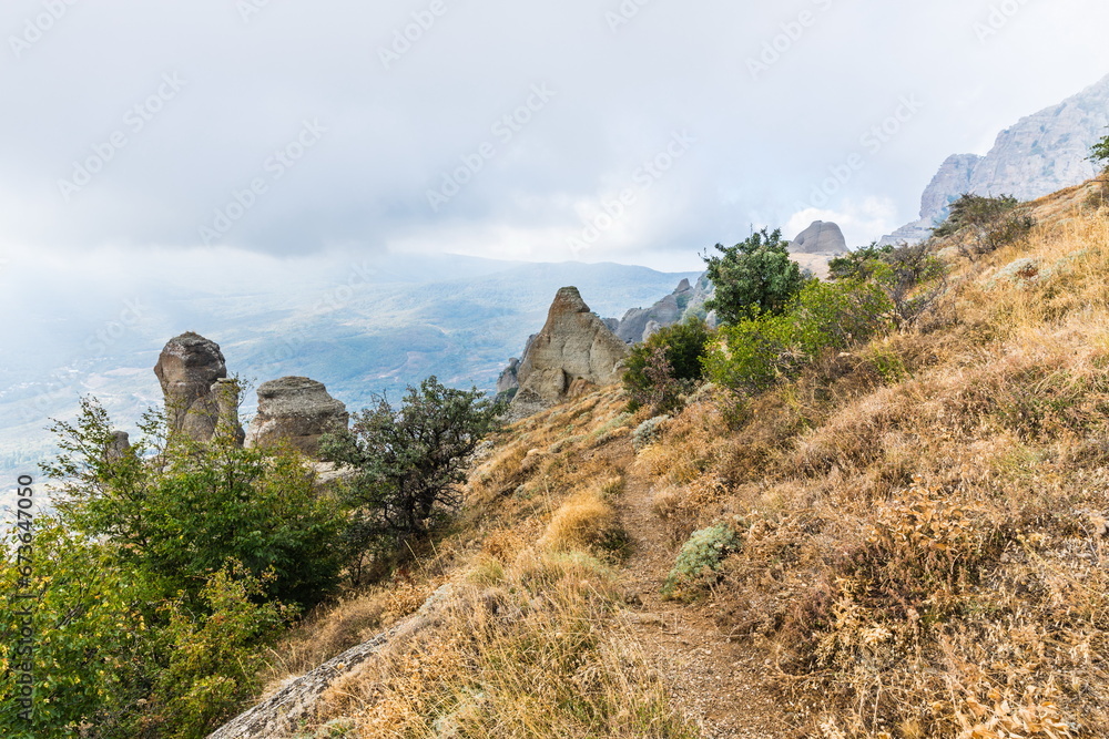 Fototapeta premium Mysterious mountain landscape of the Valley of Ghosts, a cluster of strangely shaped rocks on the western slope of Mount Demerdzhi in Crimea
