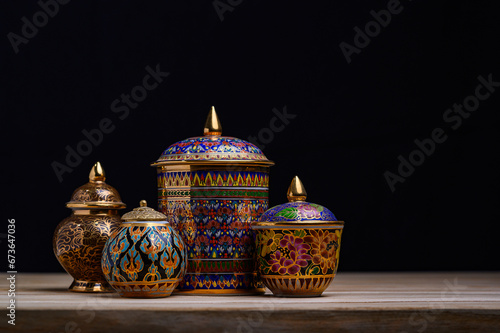 Authentic Thai Benjarong porcelain with vibrant jewel-toned patterns and gold embellishments, representing the richness of Thai cultural craftsmanship.