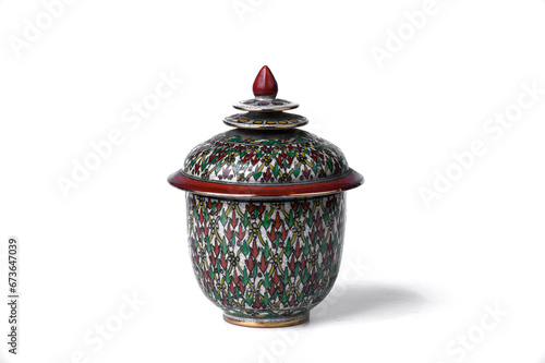 Exquisite hand-painted Thai Benjarong porcelain jar with intricate colorful patterns and a red lid, a classic representation of traditional Thai artistry.