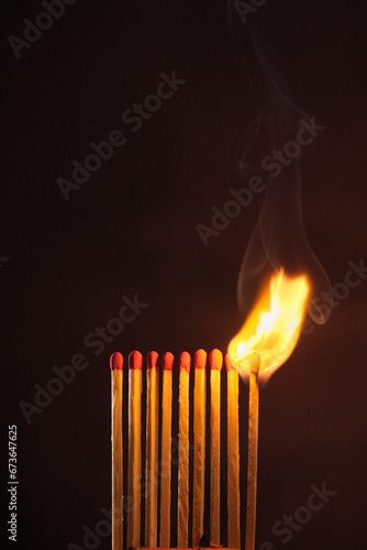 Photography a row of matches are lit on a dark background