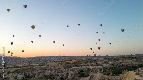 Hot air balloons. Hot air balloons flying over Fairy chimneys in Cappadocia at sunrise. Aerial view. Turkey tourist attractions