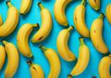 Yellow ripe sweet bananas on a blue background, top view