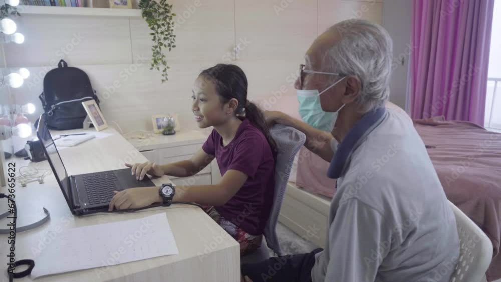 Asian grandfather and young kid study in a bedroom Asian grandfather and young kid study in a bedroom